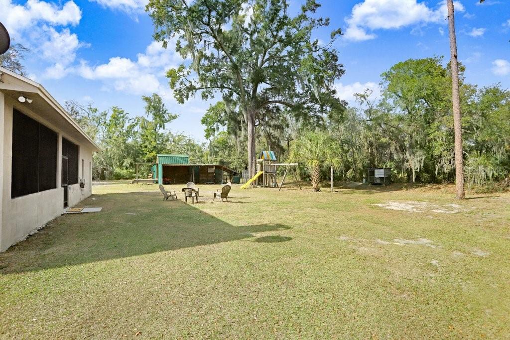 Back yard with play equipment, RV Port and Barn