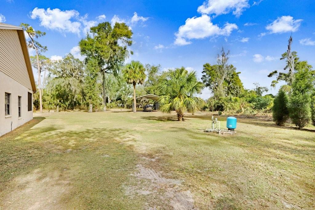 Back yard with play equipment, RV Port and Barn