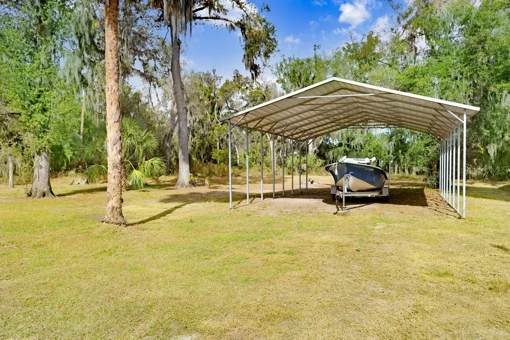 Back yard with play equipment, RV Port and Barn