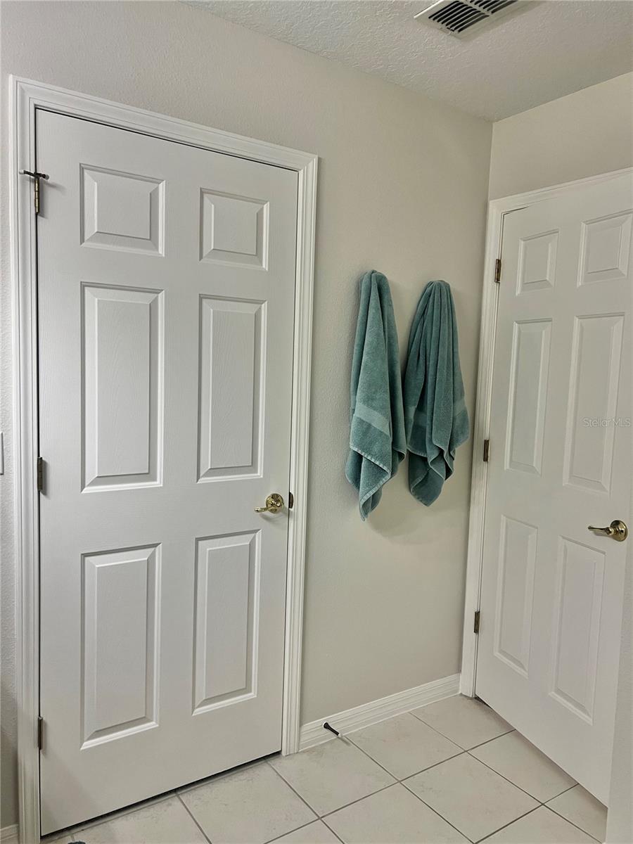 Primary bathroom has a solid wood vanity with 2 sets of cabinets and 4 drawers, Double sinks, Updated lighting, an Exhaust fan to keep humidity down, and a LARGE walk-in closet.  New towel hooks have been installed too!