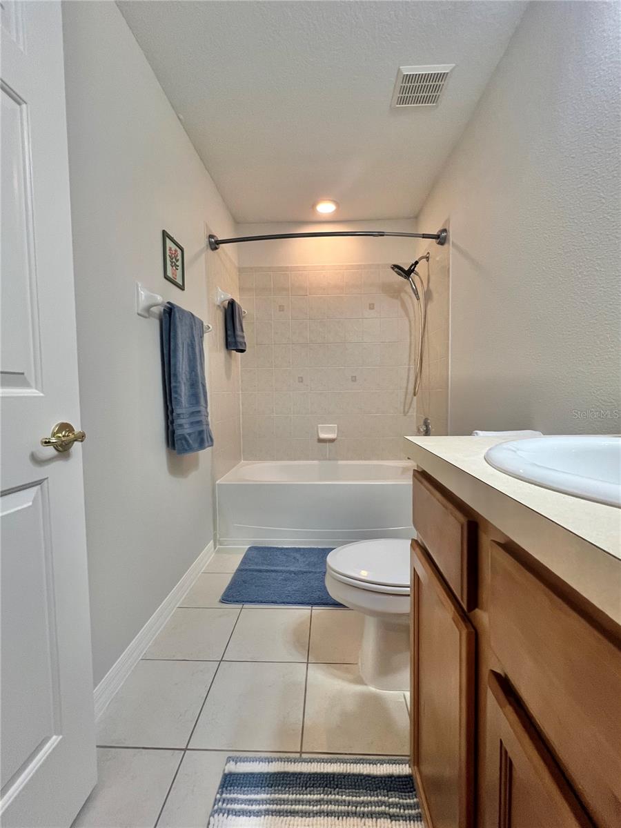 The second full bath features a double cabinet vanity, a tiled shower and oversized tub, and is very clean!