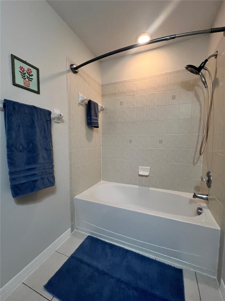 The second full bath features a double cabinet vanity, a tiled shower and oversized tub, and is very clean!