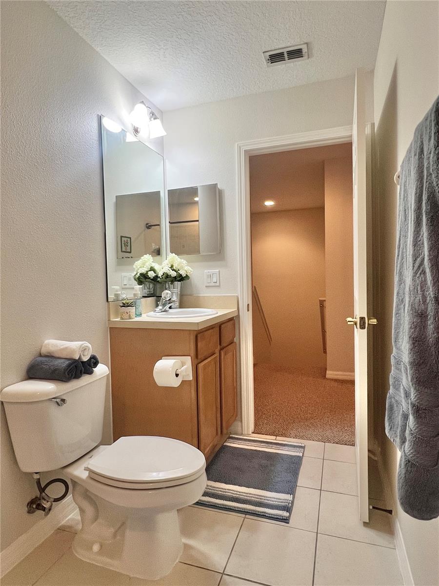 The second full bath features a double cabinet vanity, updated lighting, a tiled shower and oversized tub, and is very clean!