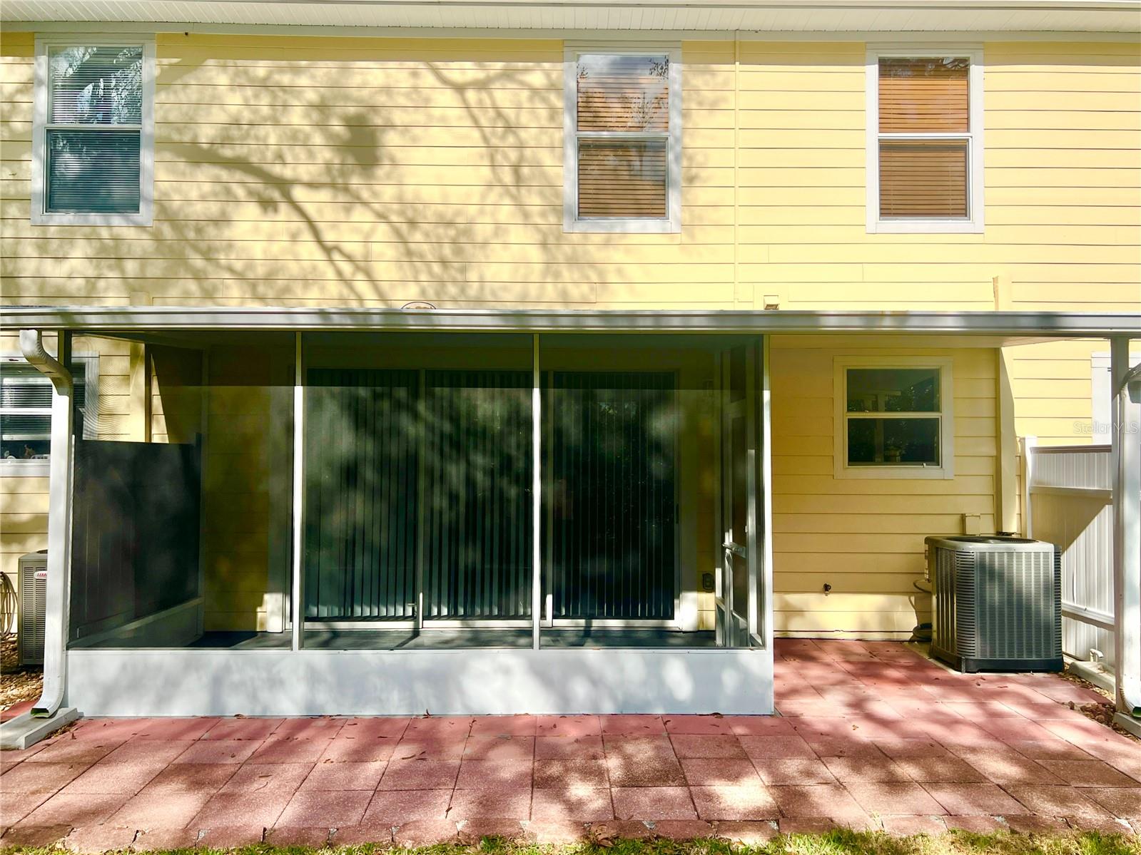 There's a brick-pavered patio outside the screened-in area, a great lounging space, a grilling area, or a long stretch for cornhole competition!