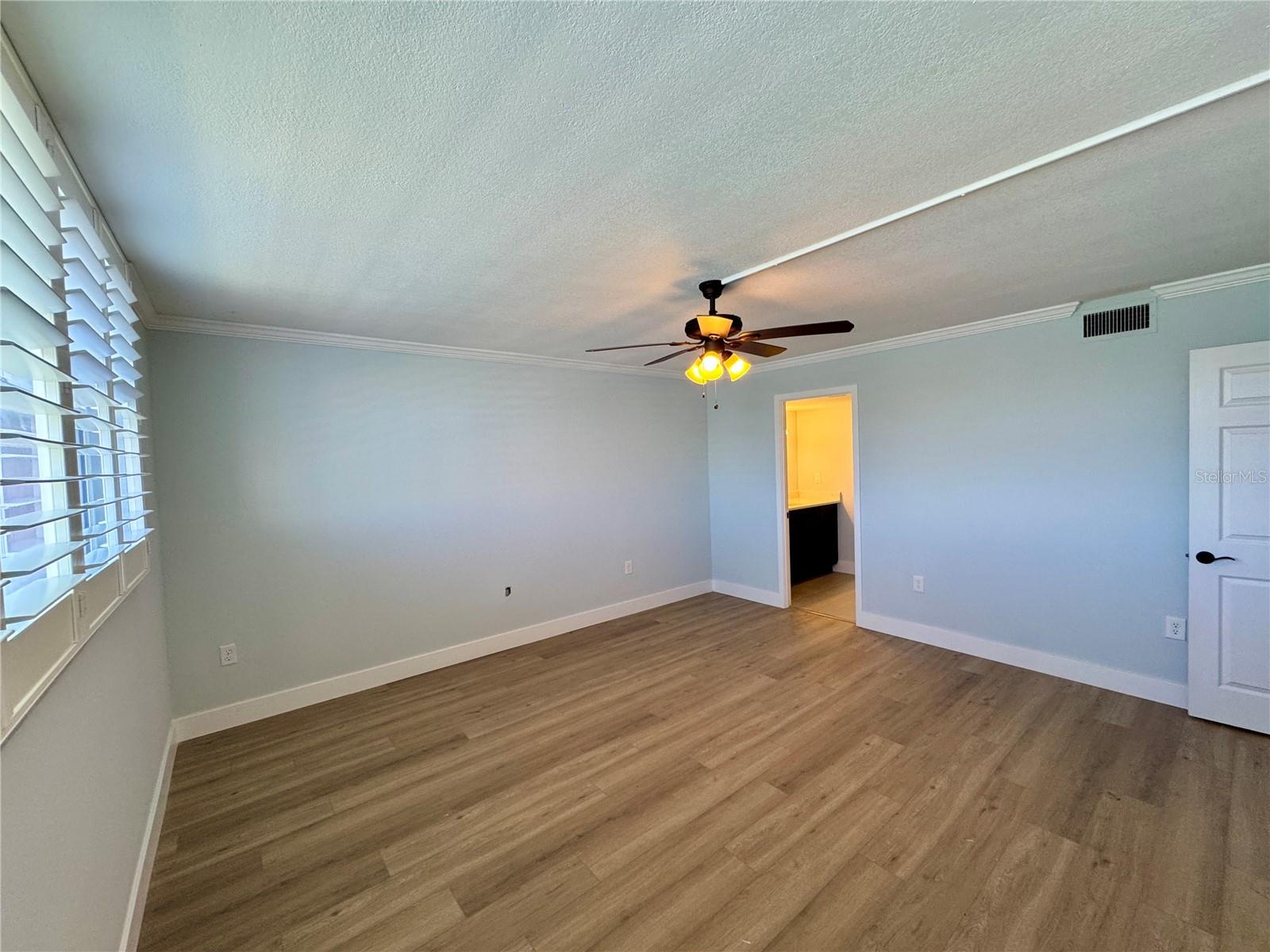 PRIMARY BEDROOM PLANTATION SHUTTERS AND HURRICANE IMPACT WINDOWS