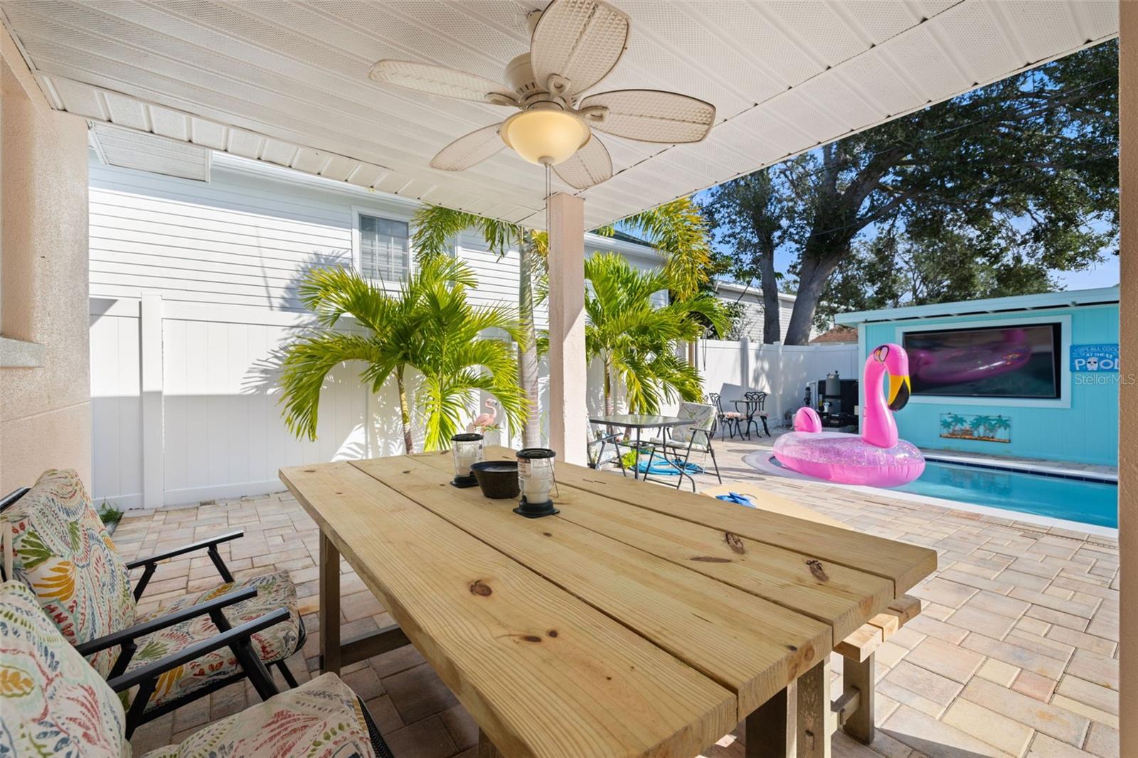 Covered patio with grill overlooking the pool area is a great place to hangout rain or shine. The backyard faces east so it's enjoyable in the afteroons which guests love.