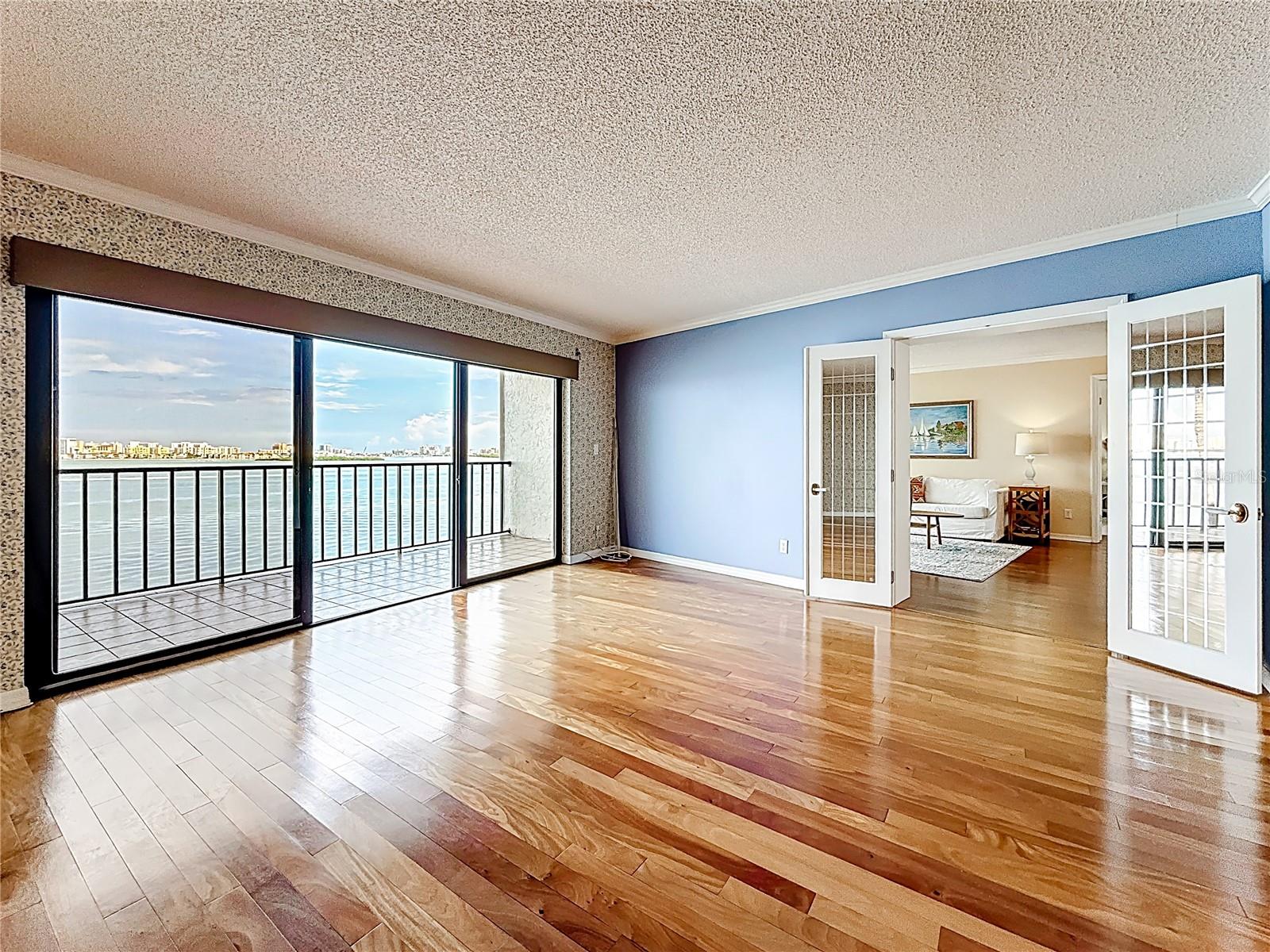 Family room / Flex space to Left of Living room, with hardwood floors and separate balcony