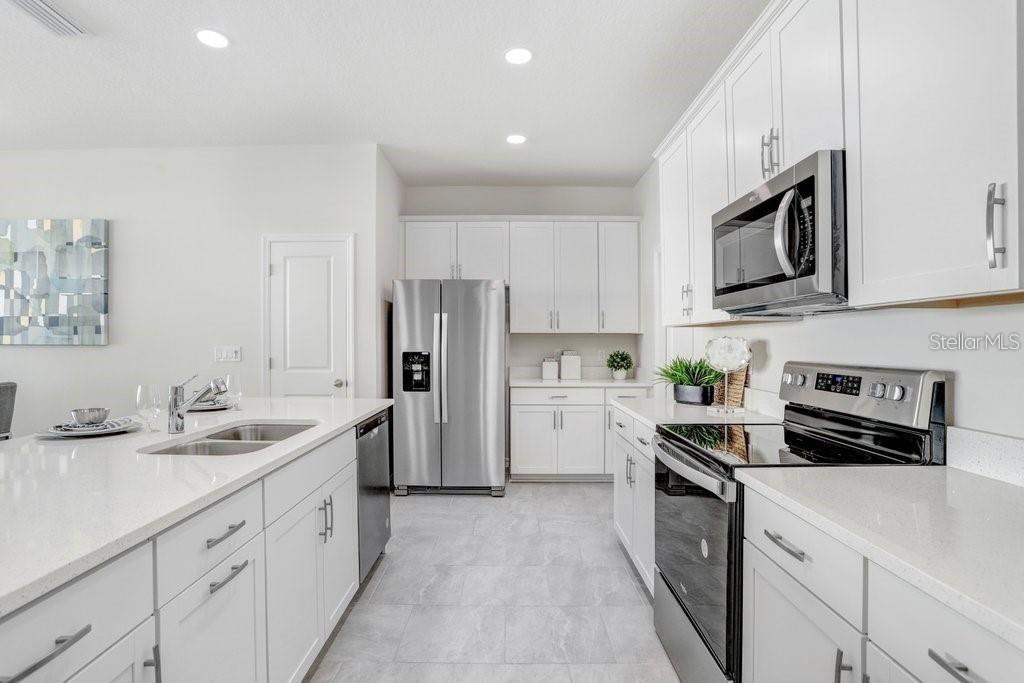 Kitchen with Lots of Cabinet Space and Big Pantry! (photo of model home)