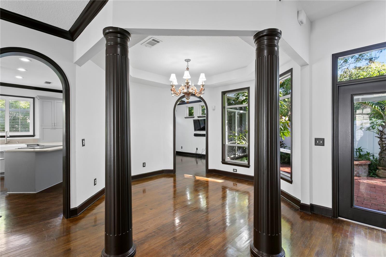 A beautiful chandelier and elegant columns anchor the dining room.