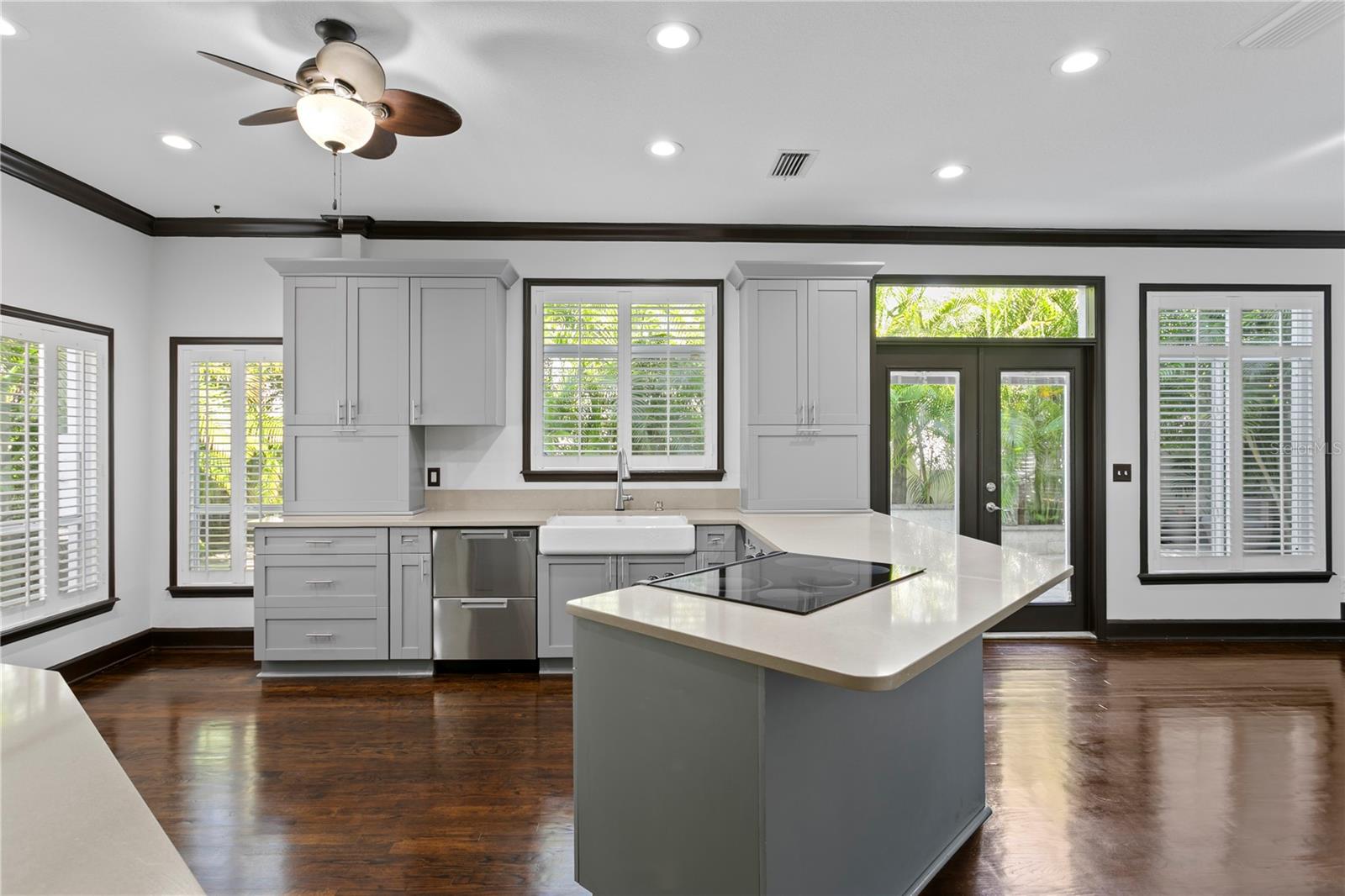 The stunning light-filled kitchen features modern updates and beautiful cabinetry.
