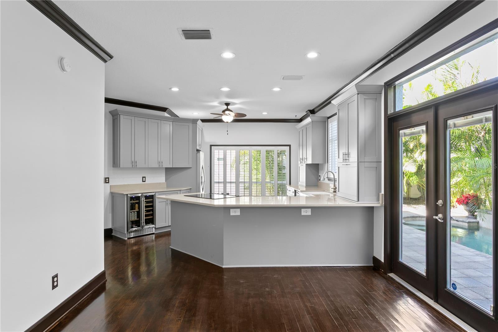 Double doors feature integrated blinds and lead to the private backyard.