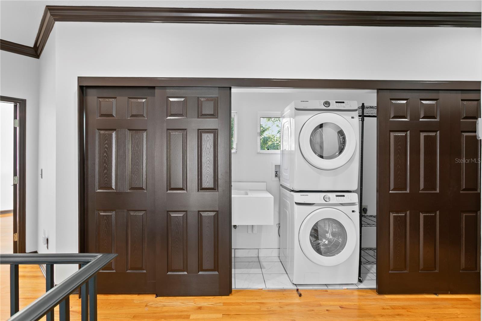 The convenient upstairs laundry closet is equipped with a stacked washer and dryer (2025).