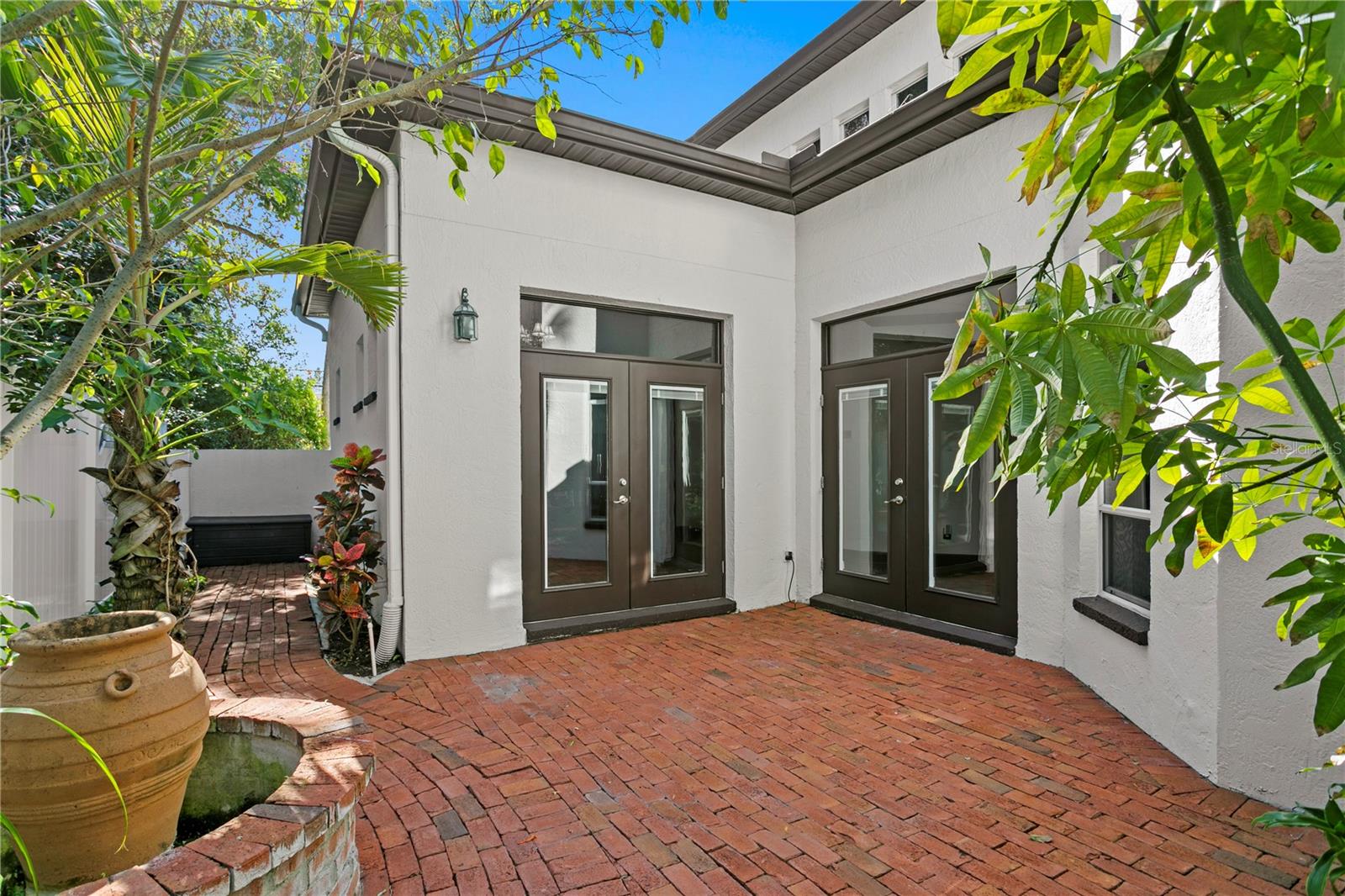 The brick pavered courtyard is a perfect spot for morning coffee or intimate gatherings.