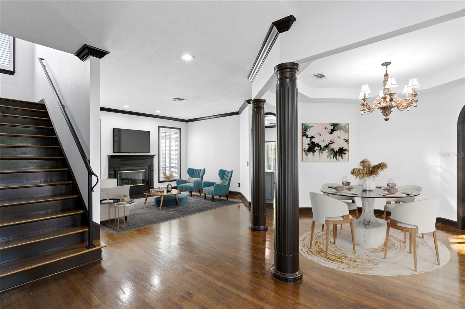 The living and dining rooms connect effortlessly, featuring beautiful hardwood floors found throughout the home.