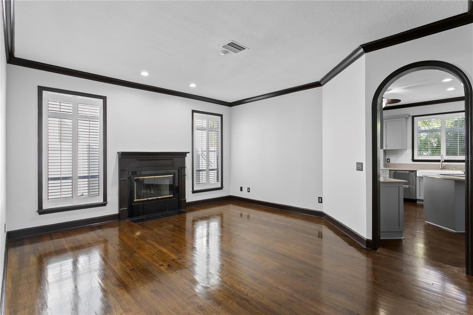 This bright living room is centered around a wood-burning fireplace.