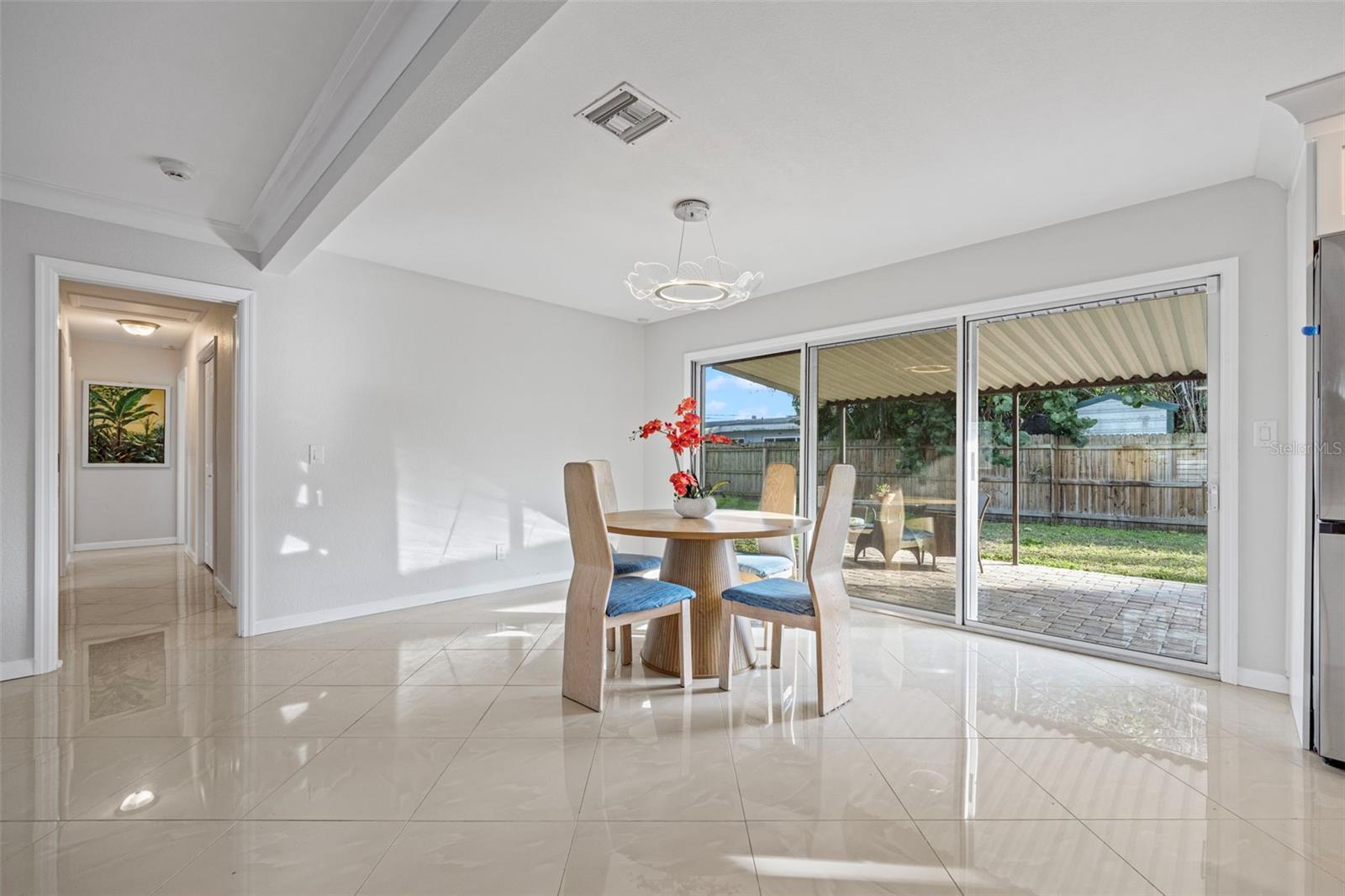 view of dining area and bedroom hallway from garage door