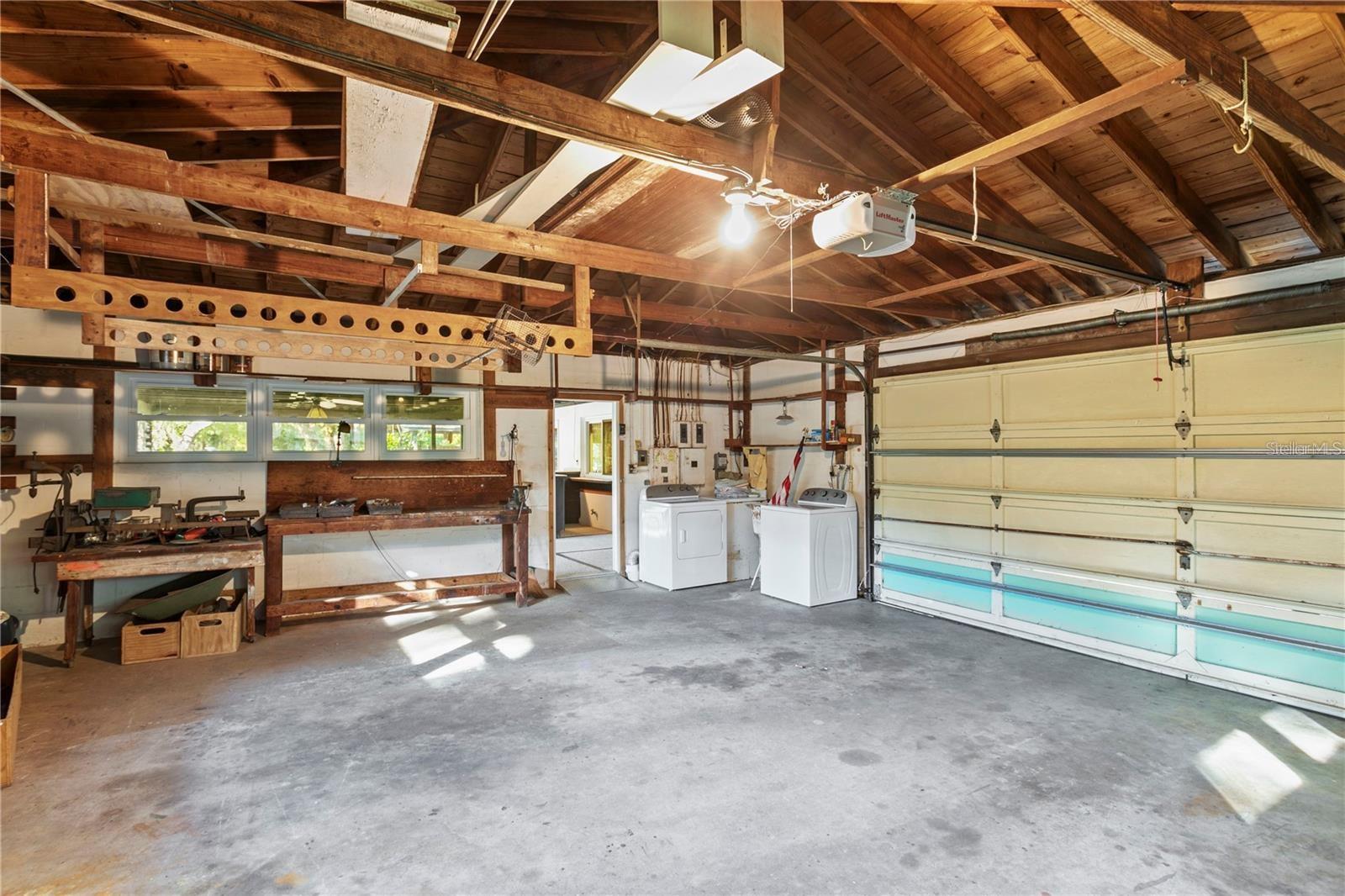 x large garage with washer dryer opens to patio area
