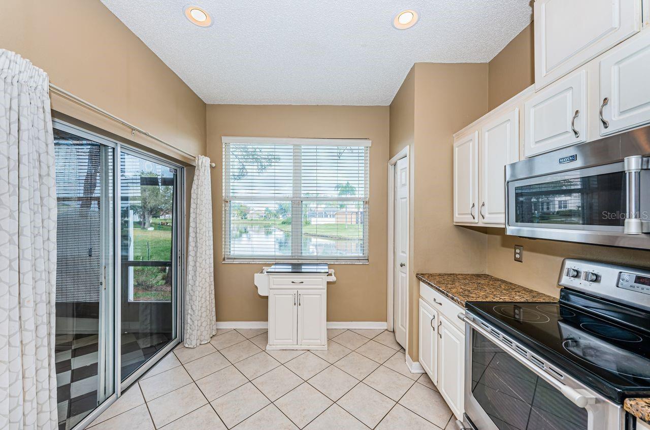 Kitchen opens to lanai and view of pond