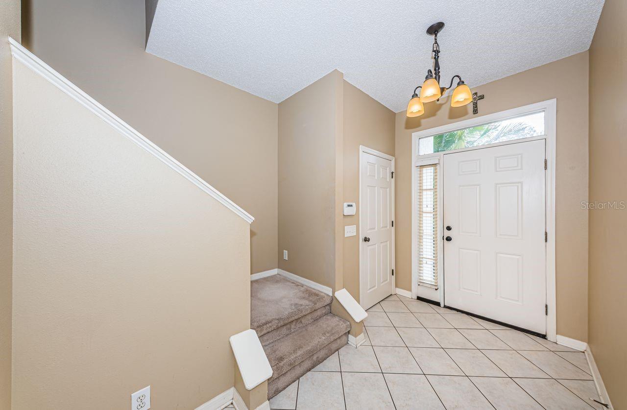 Front door in foyer, Powder room (half bathroom) just to the left of the front door