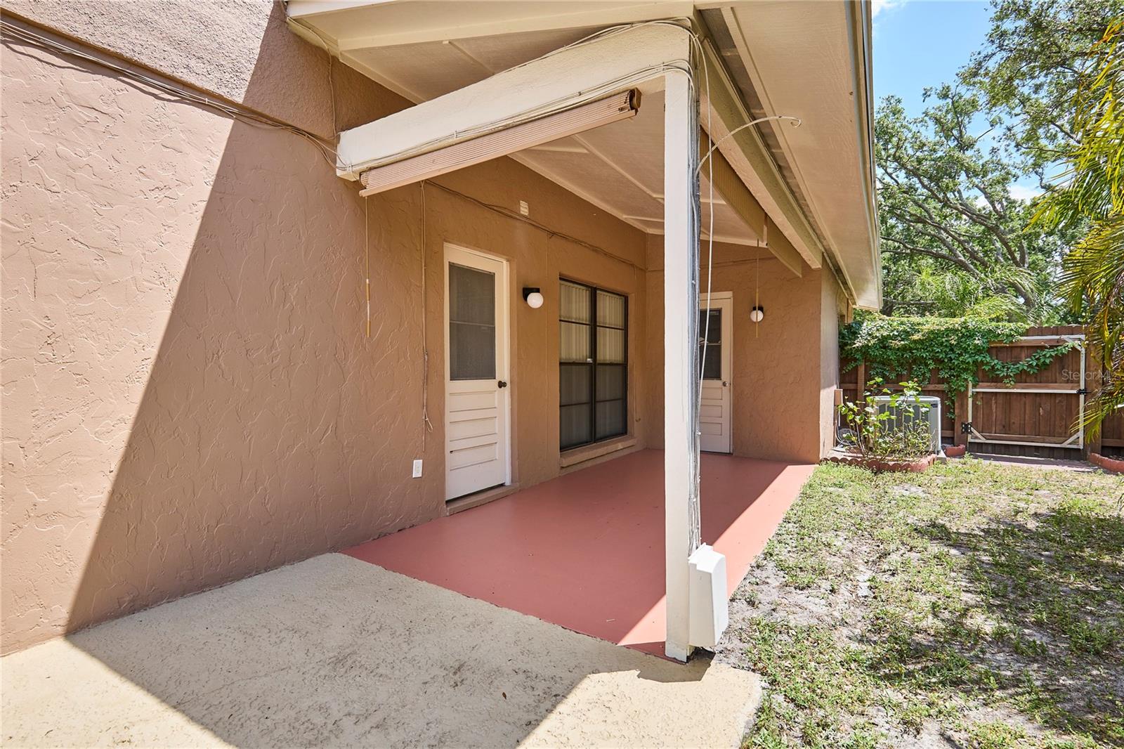 Side Porch. 2nd entrance to Kitchen and garage.