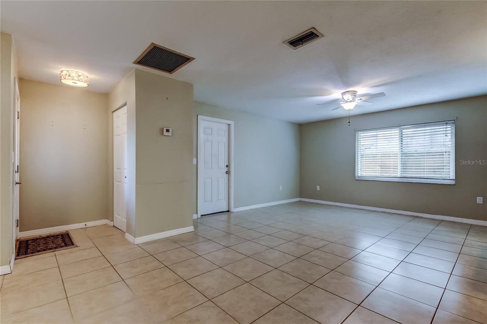 Front foyer area, and family room looking towards garage door.