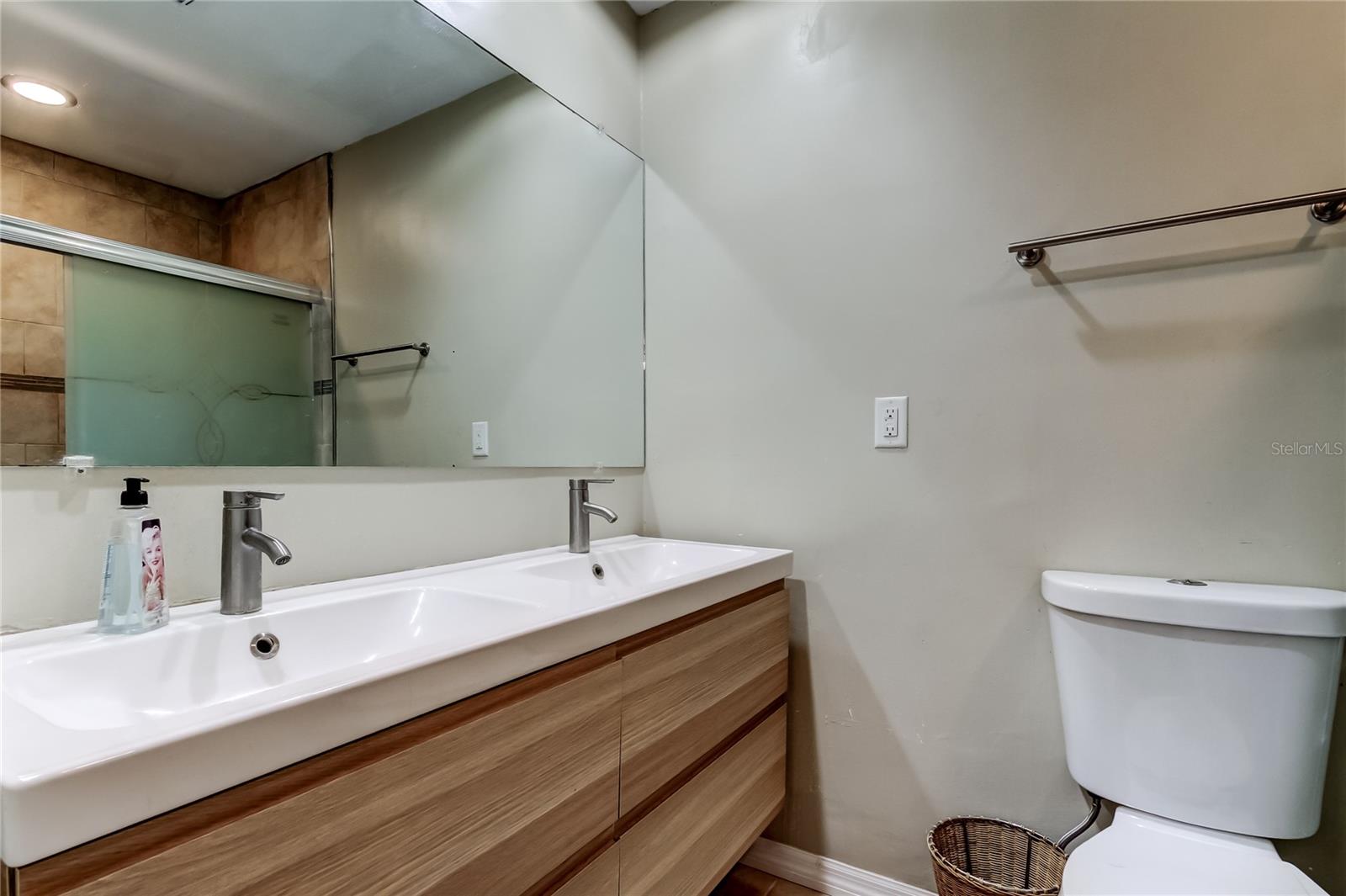 Primary bathroom with dual floating sink.
