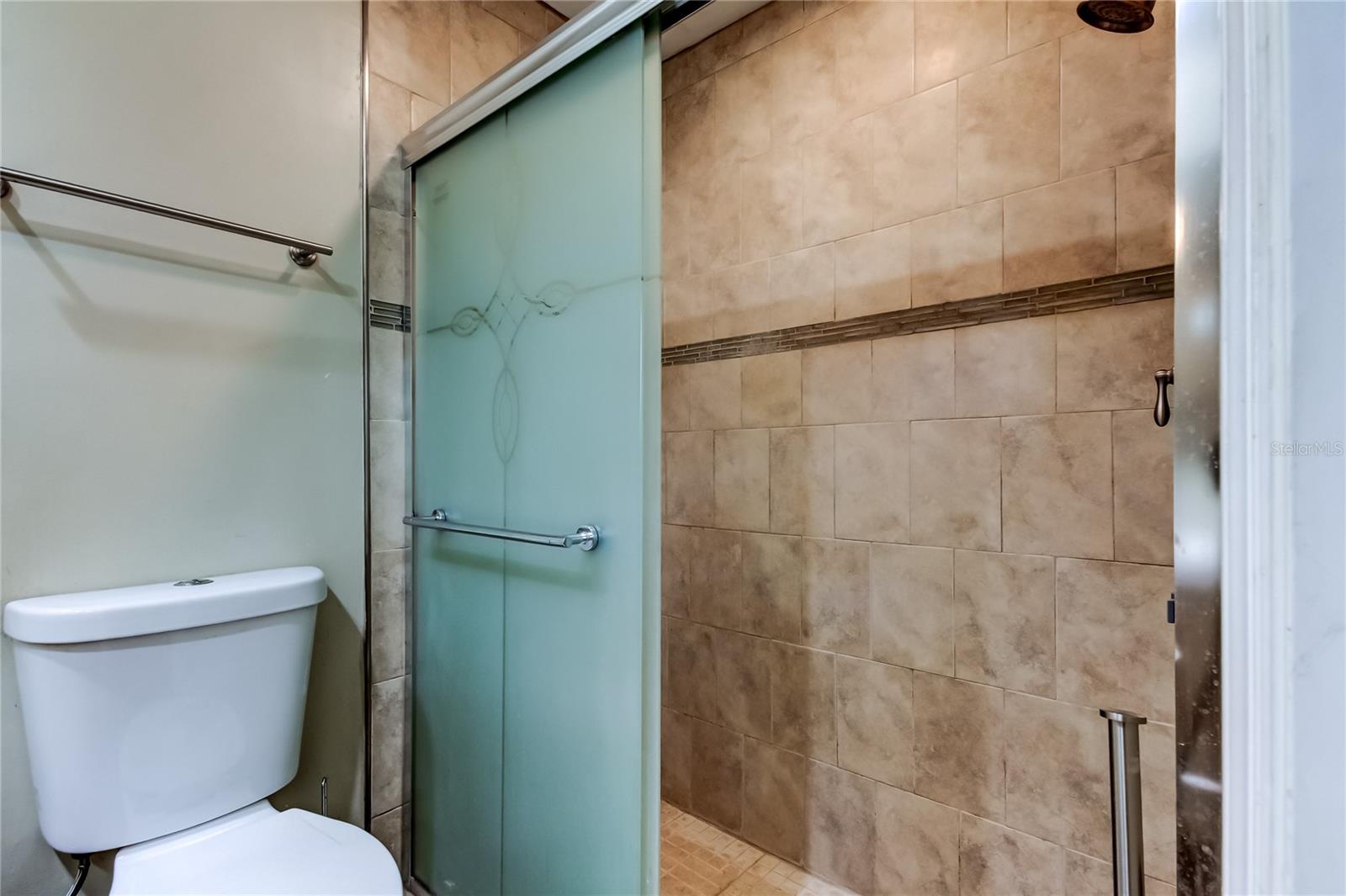 Primary tiled shower area.