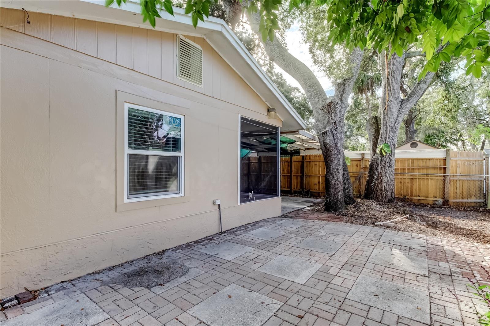 Back yard looking towards bonus room and screen enclosed patio.