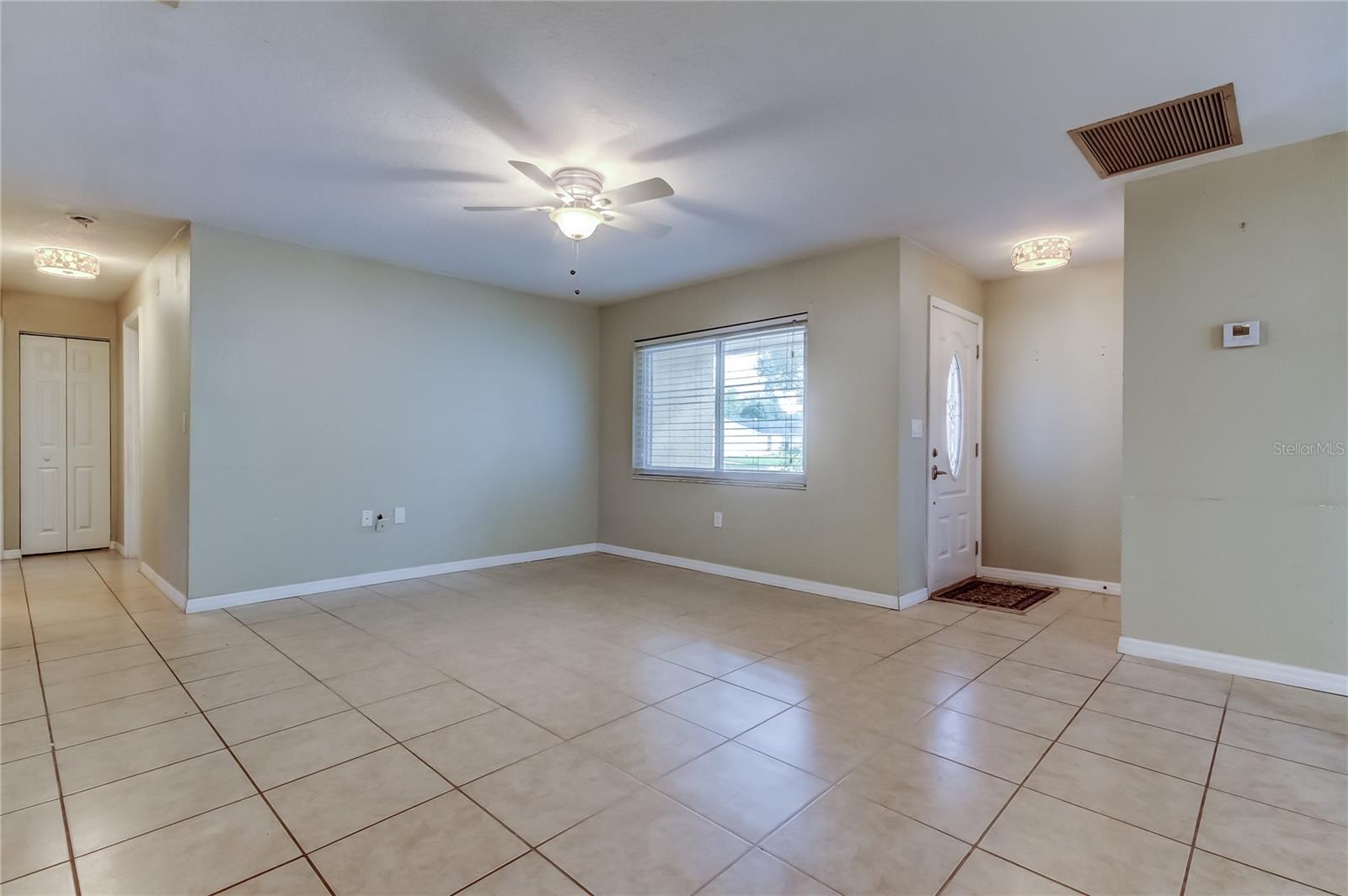 Living room looking towards front door, and hallway towards bedrooms.