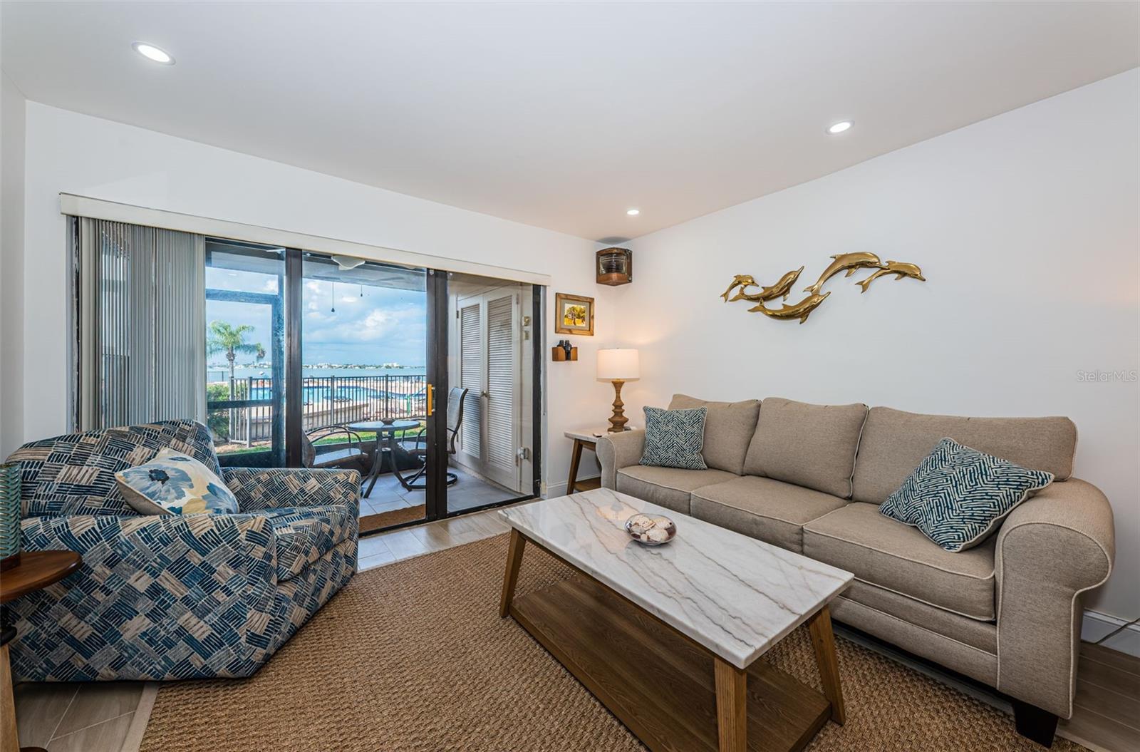 Main living space with sliding doors opening to the screened patio