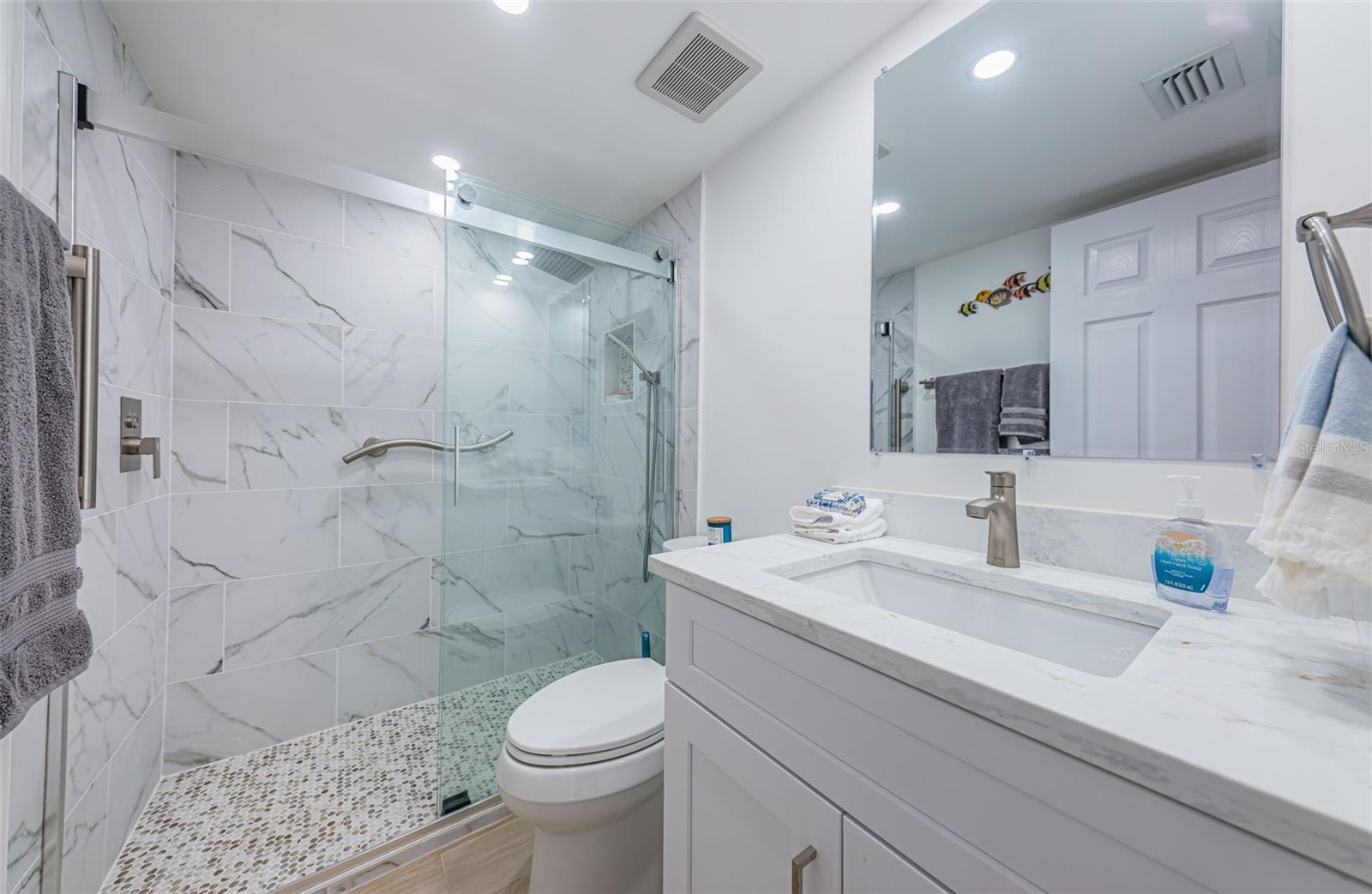 Remodeled guest bath coordinates with master bath