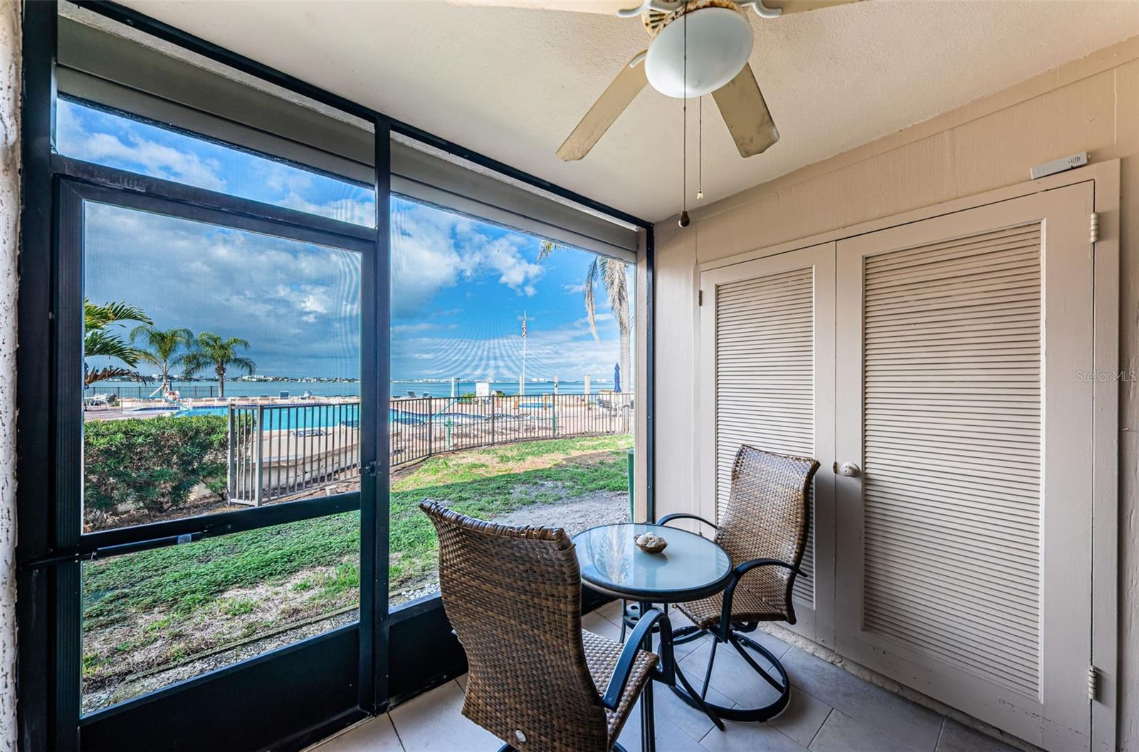 Screened patio overlooks the pool and Boca Ciega Bay