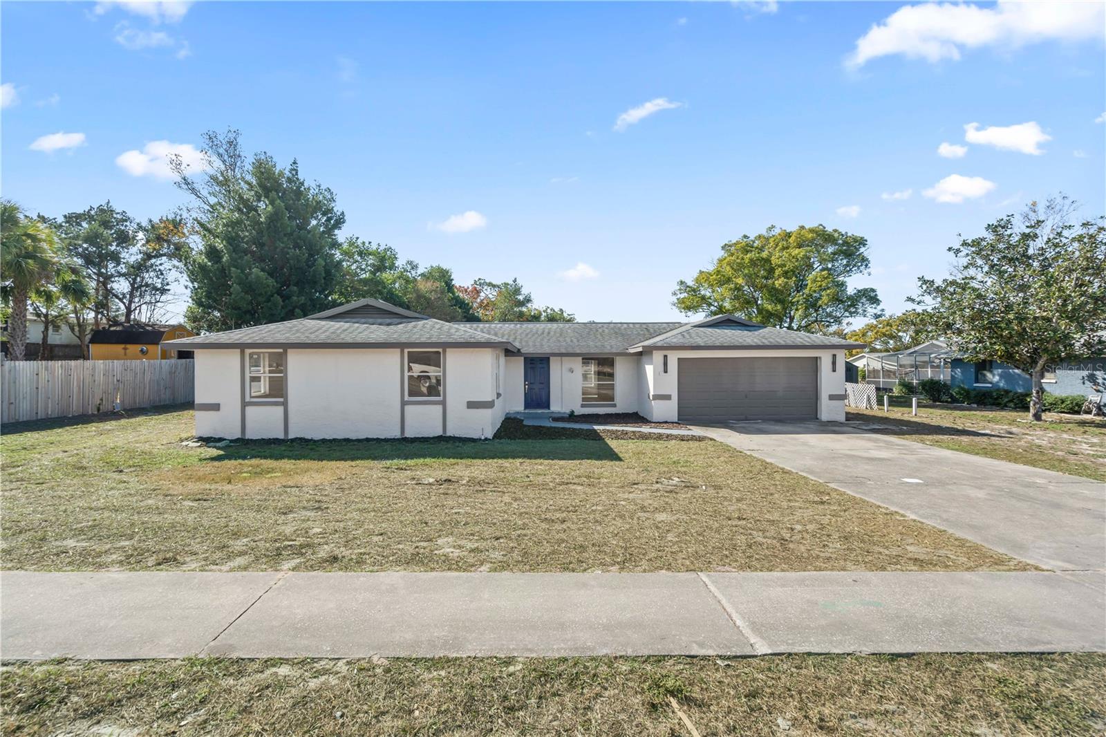 Front exterior view showcasing spacious lot and driveway