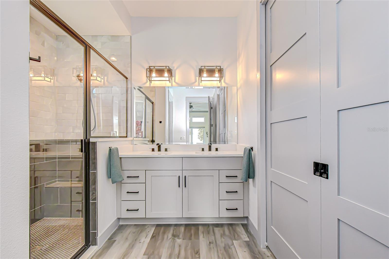 Glass enclosed shower and French pocket doors to closet!