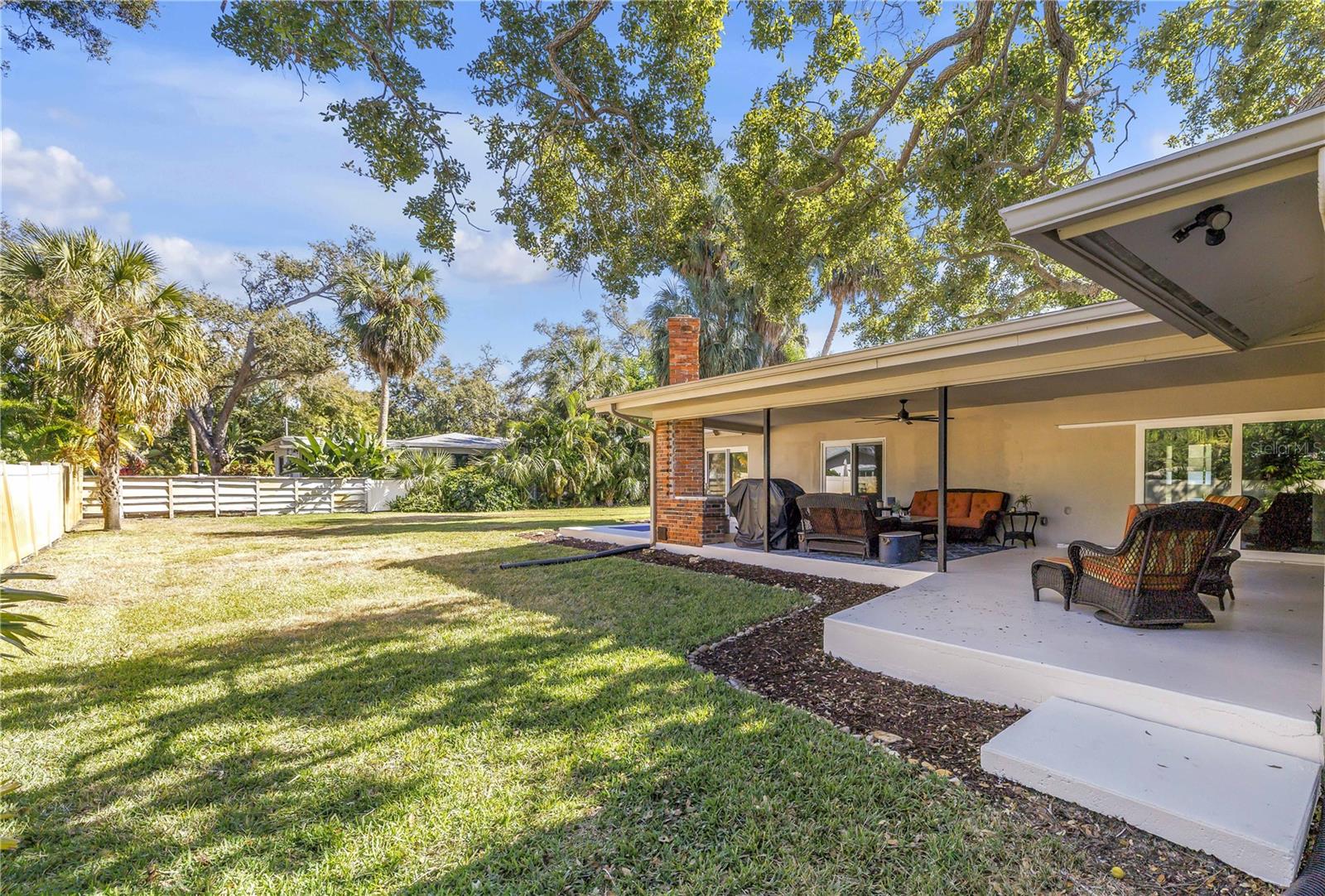Expansive covered porch with a perfect opportunity to grill entertain and enjoy this great yardspace