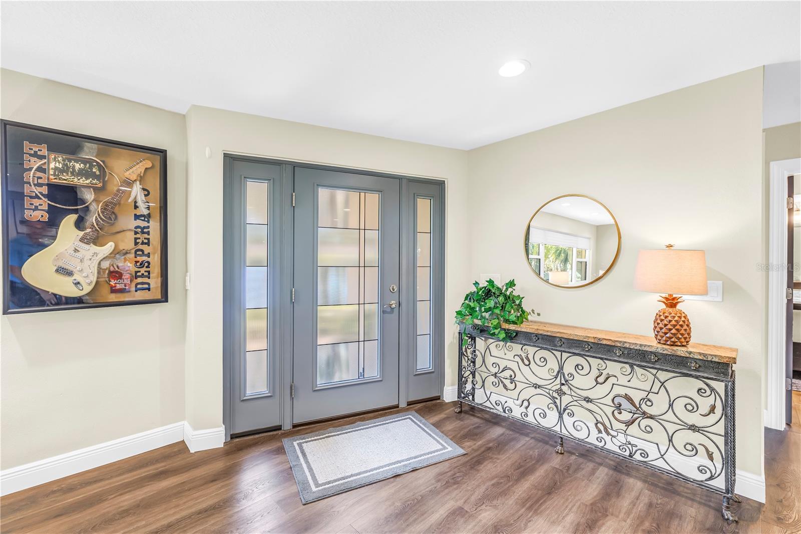 Classic mid century front door with side lights all rated for hurricanes and a full update to the appearance.