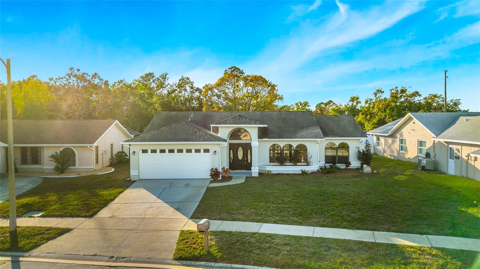 Front of home lots of natural light throughout with the many windows and sliding doors!