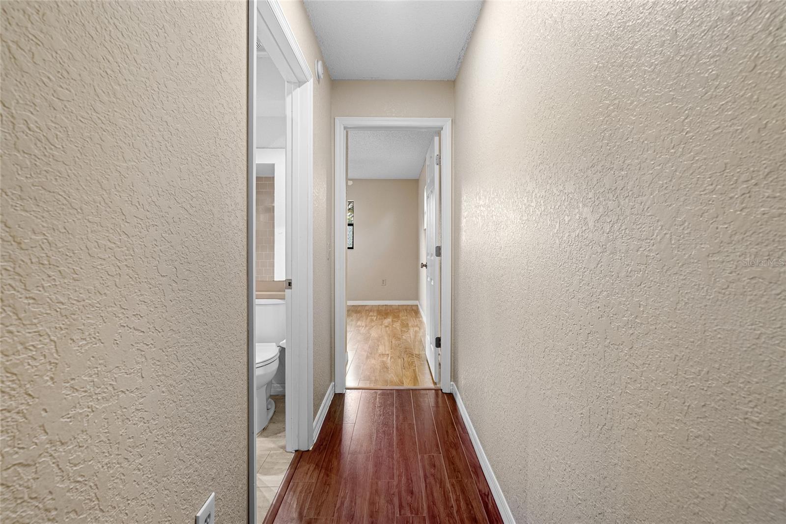 hallway to bathroom and second bedroom