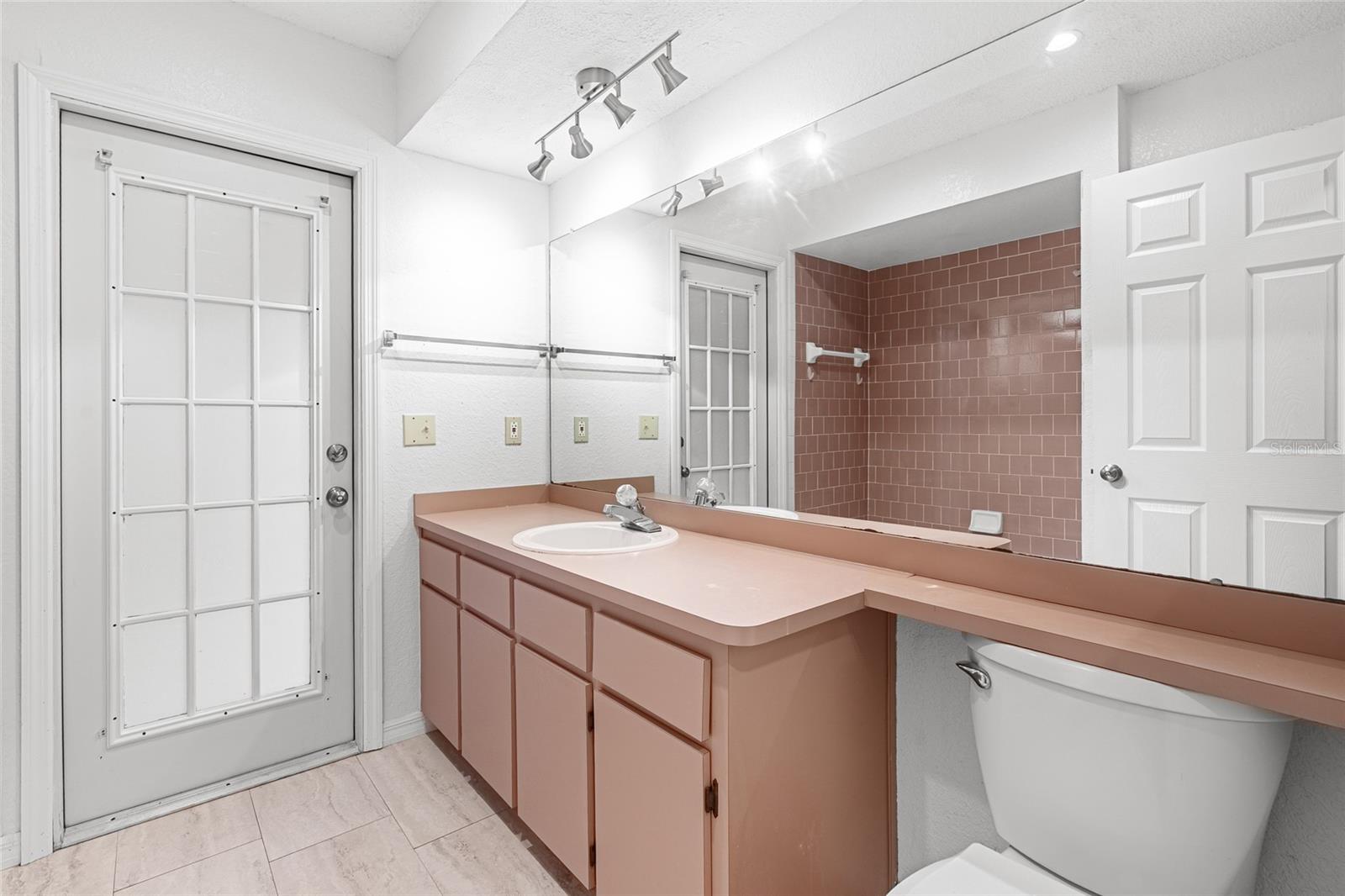 Bathroom with a door to the rear patio, perfect to add that inground pool :)