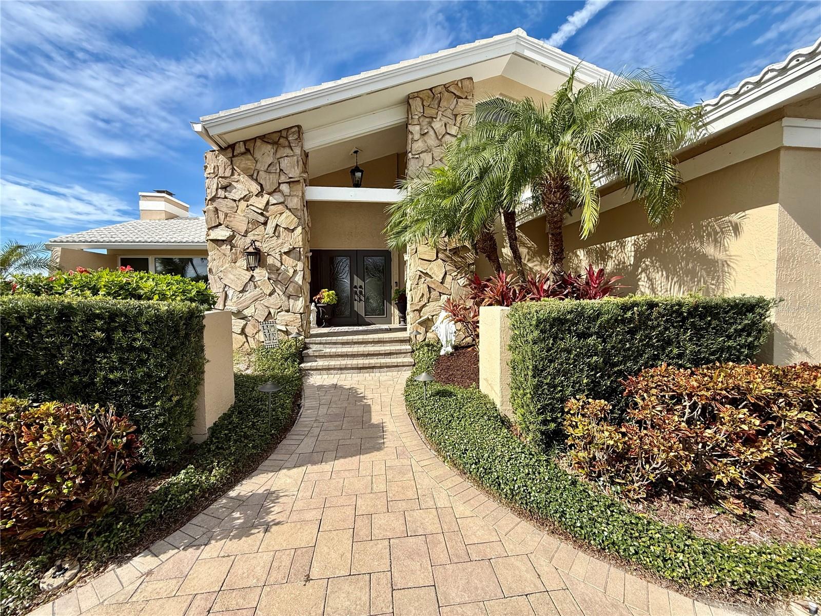 Pavers lead to inviting entrance door.