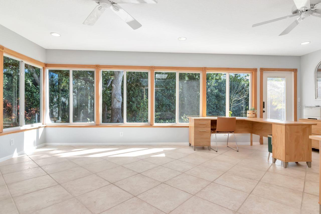 Wall to wall windows in this expansive Florida Room with a new mini-split AC