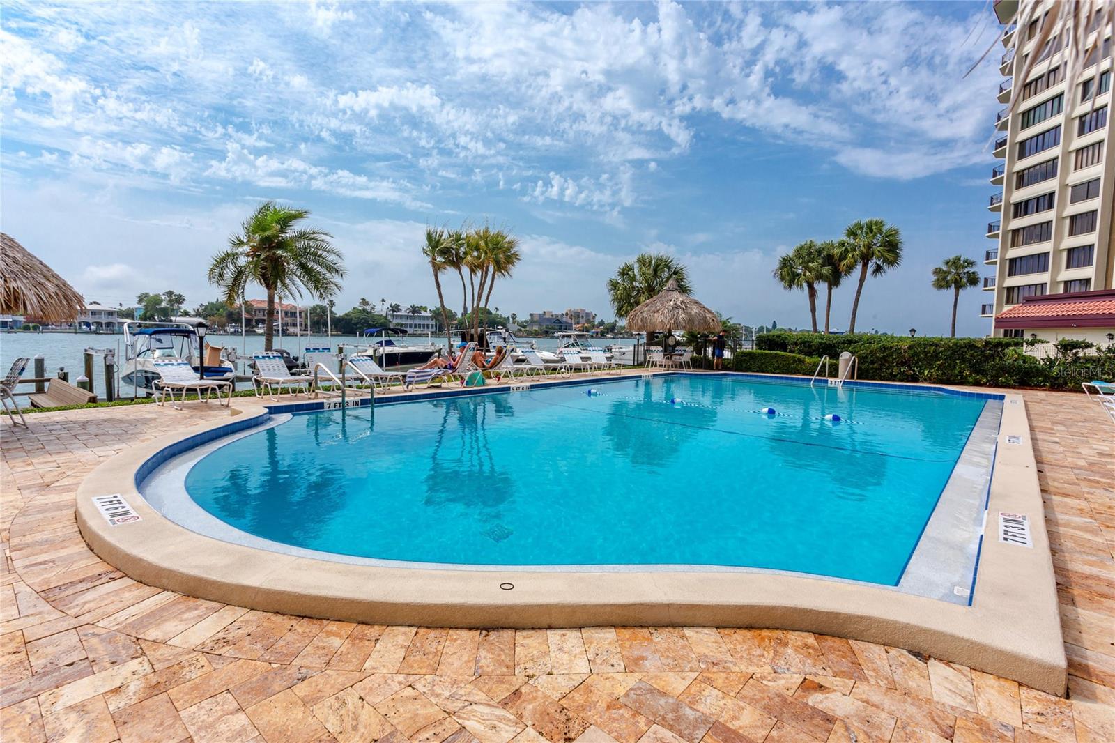 Beautiful waterfront pool with pavered deck