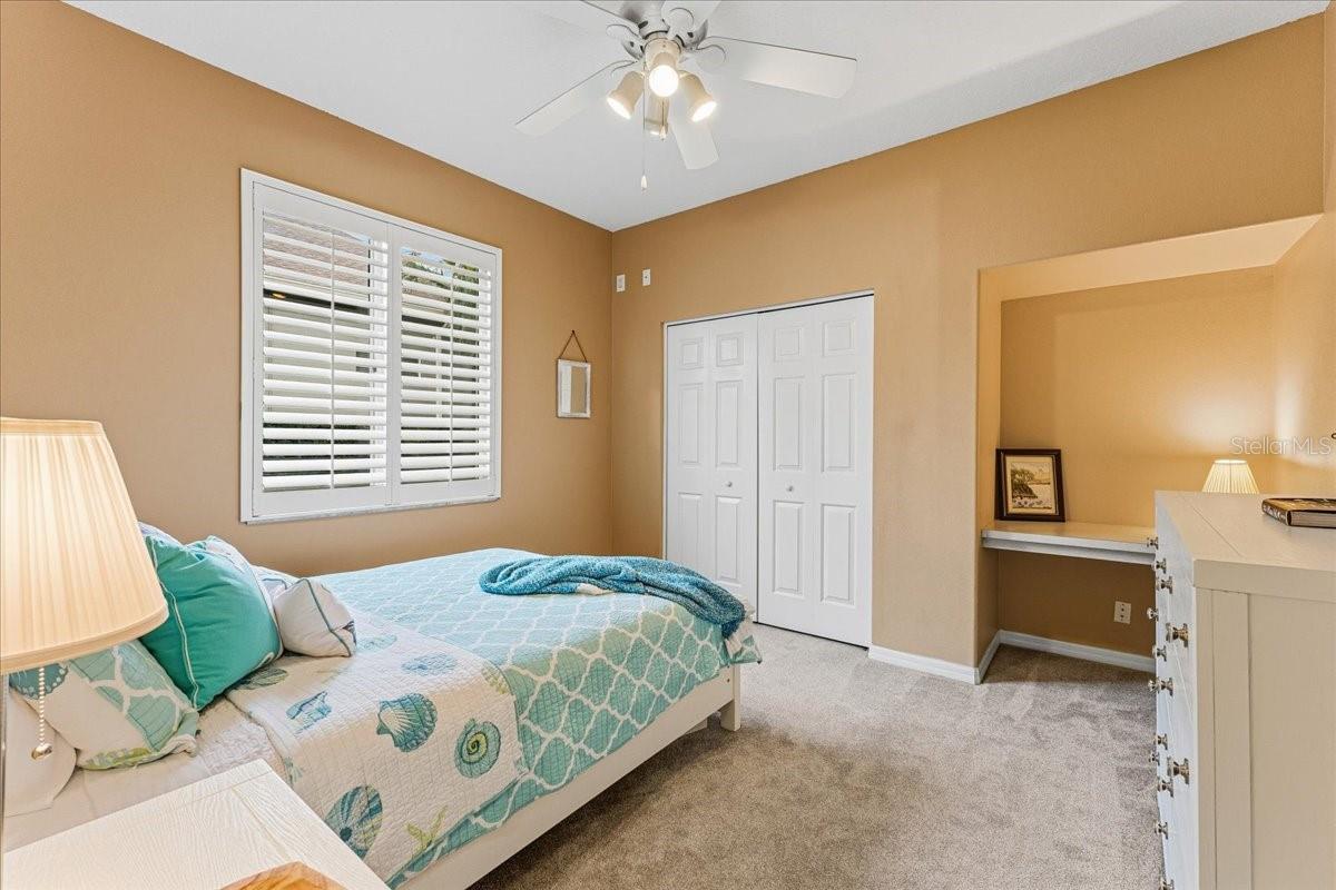Bedroom #2 with ceiling fan and desk area