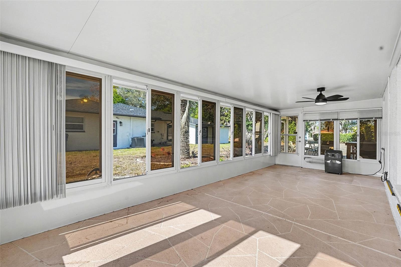 Patio with windows and A/C unit