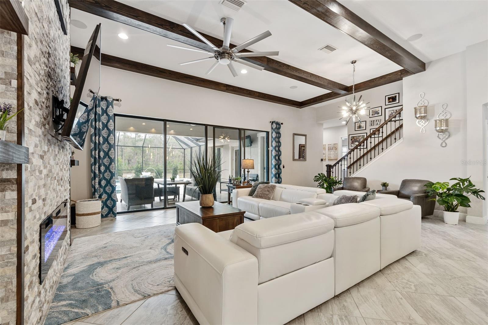 ENJOY THE UPGRADED GRAND ROOM ACCENT WALLS & BEAMS IN A LUXURIOUS OPEN PLAN & EXQUISITE POOL VIEWS
