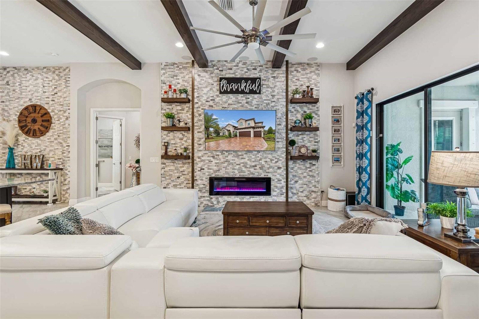 ENJOY THE UPGRADED GRAND ROOM ACCENT WALLS & BEAMS IN A LUXURIOUS OPEN PLAN & EXQUISITE POOL VIEWS