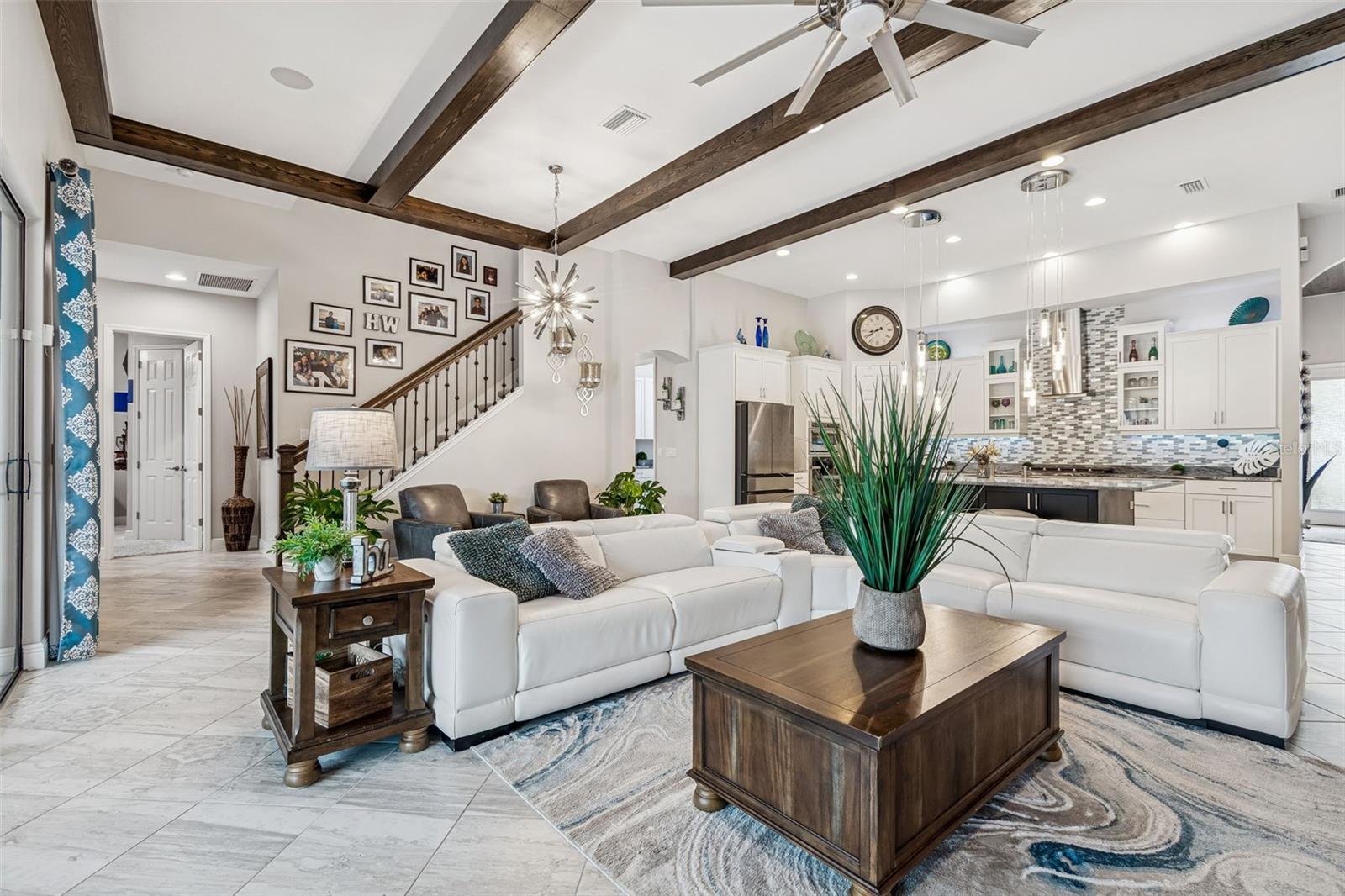 ENJOY THE UPGRADED GRAND ROOM ACCENT WALLS & BEAMS IN A LUXURIOUS OPEN PLAN & EXQUISITE POOL VIEWS