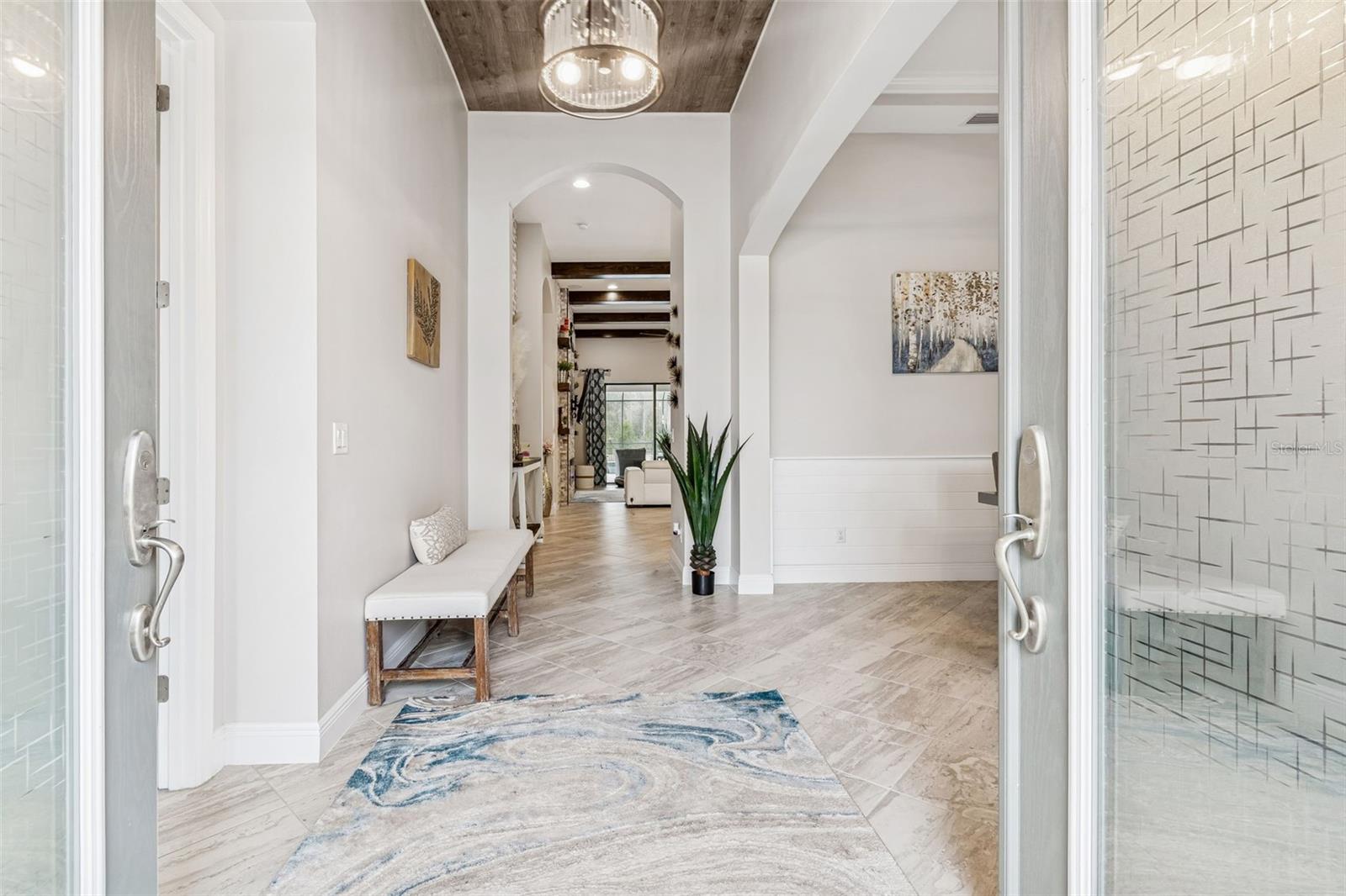 GRAND FOYER W/DOUBLE DOOR  ENTRANCE + WOOD CEILING ACCENTS