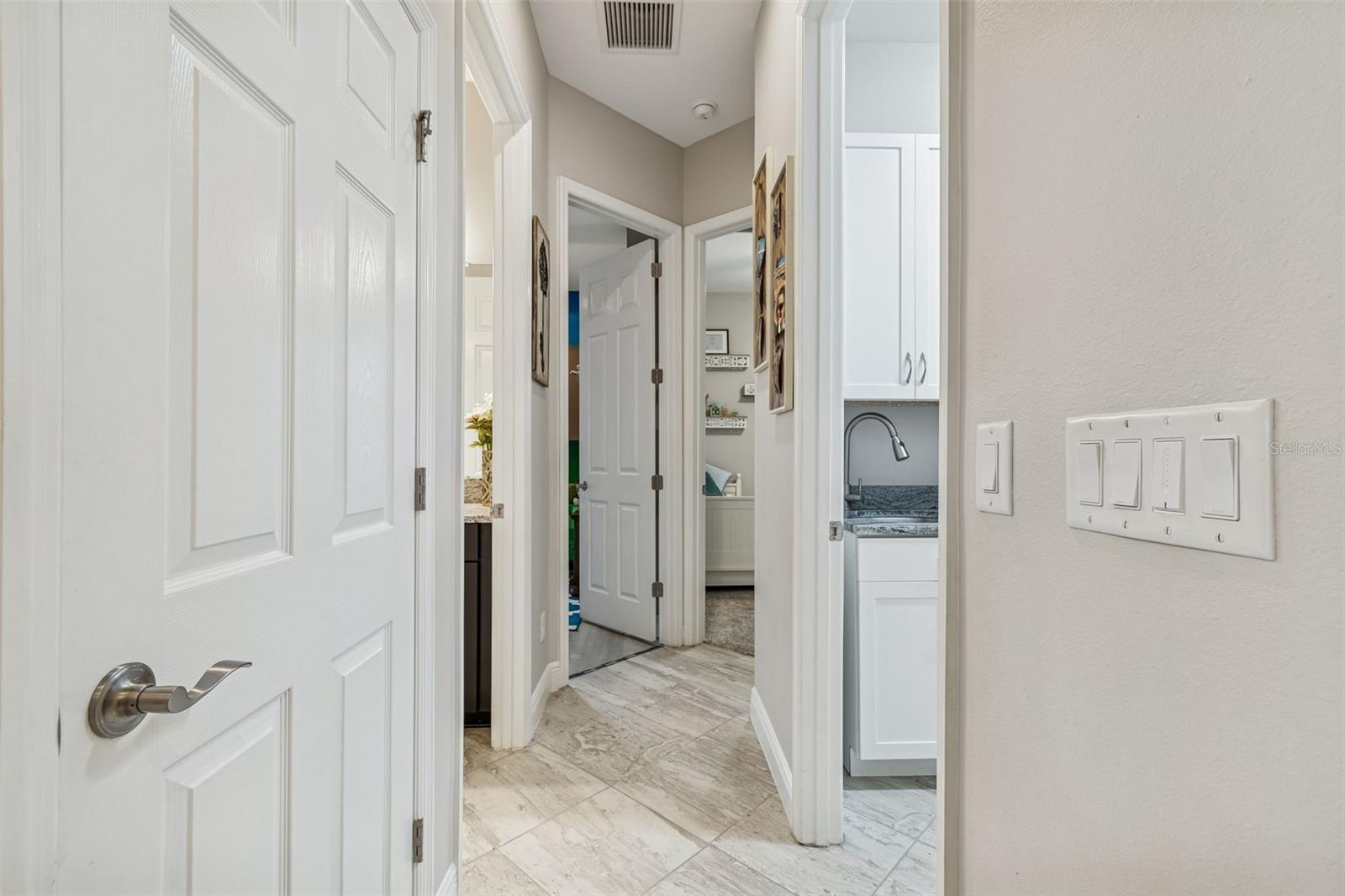 HALLWAY TO BEDROOM #2 & #3 AND LAUNDRY ROOM TO THE RIGHT & GARAGE
