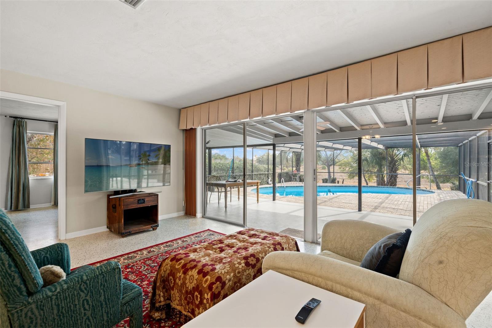 Sliding glass doors leading to the pool